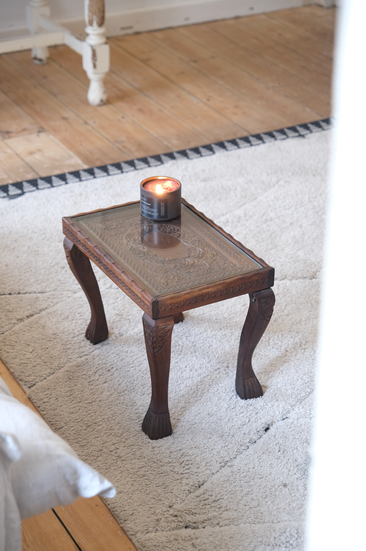 Wood carved stool with glass top