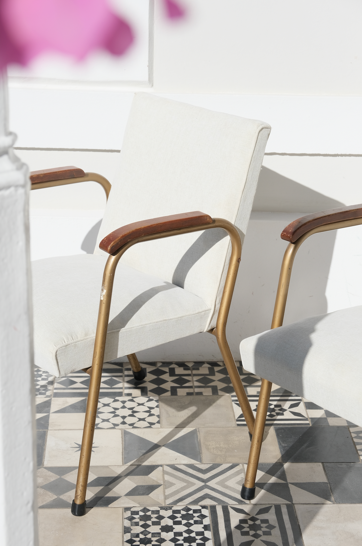 A pair of occasional chairs reupholstered with an off-white fabric