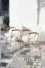 Load image into Gallery viewer, A pair of occasional chairs reupholstered with an off-white fabric
