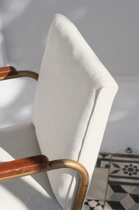 A pair of occasional chairs reupholstered with an off-white fabric