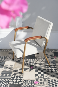 A pair of occasional chairs reupholstered with an off-white fabric