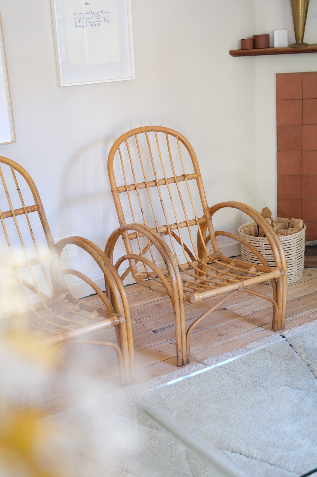 Pair of cane chairs with flower print cushions