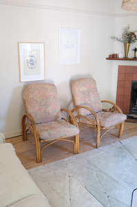 Pair of cane chairs with flower print cushions