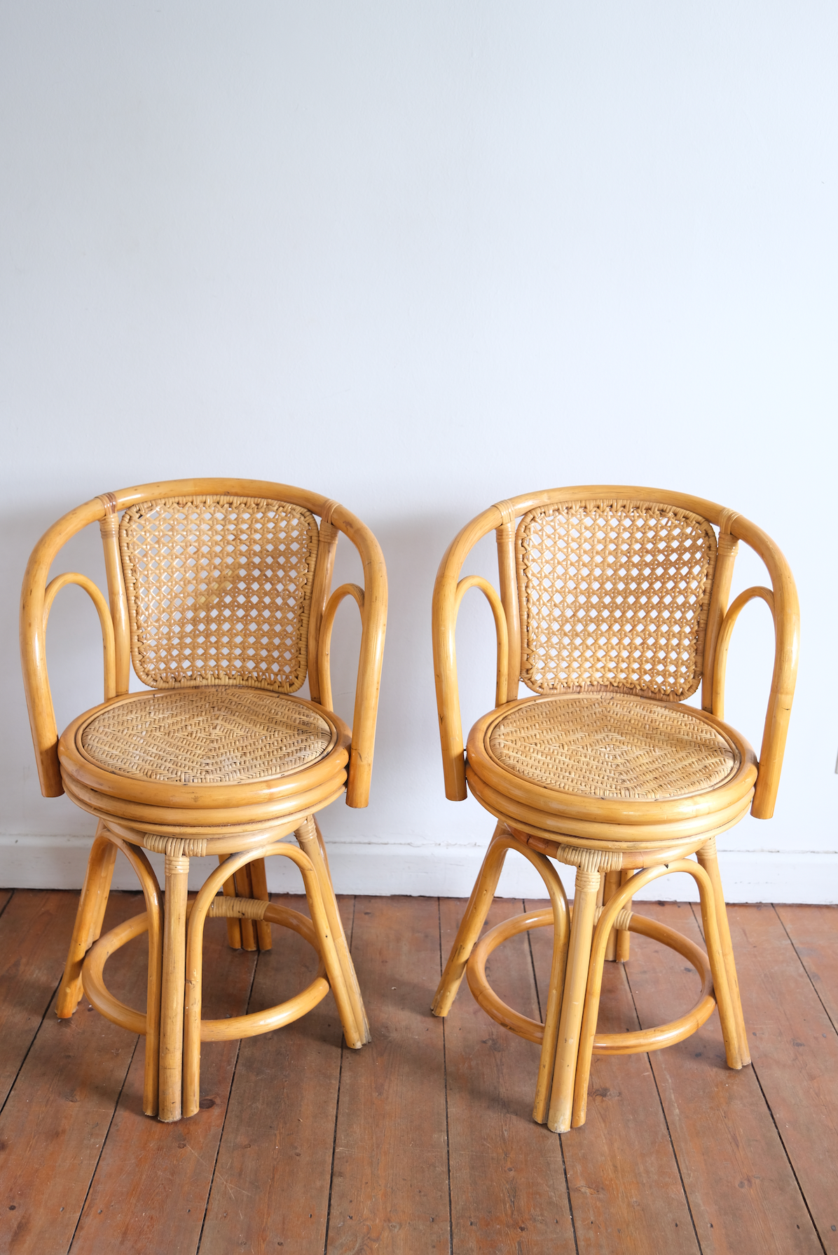 Pair of swivel cane chairs