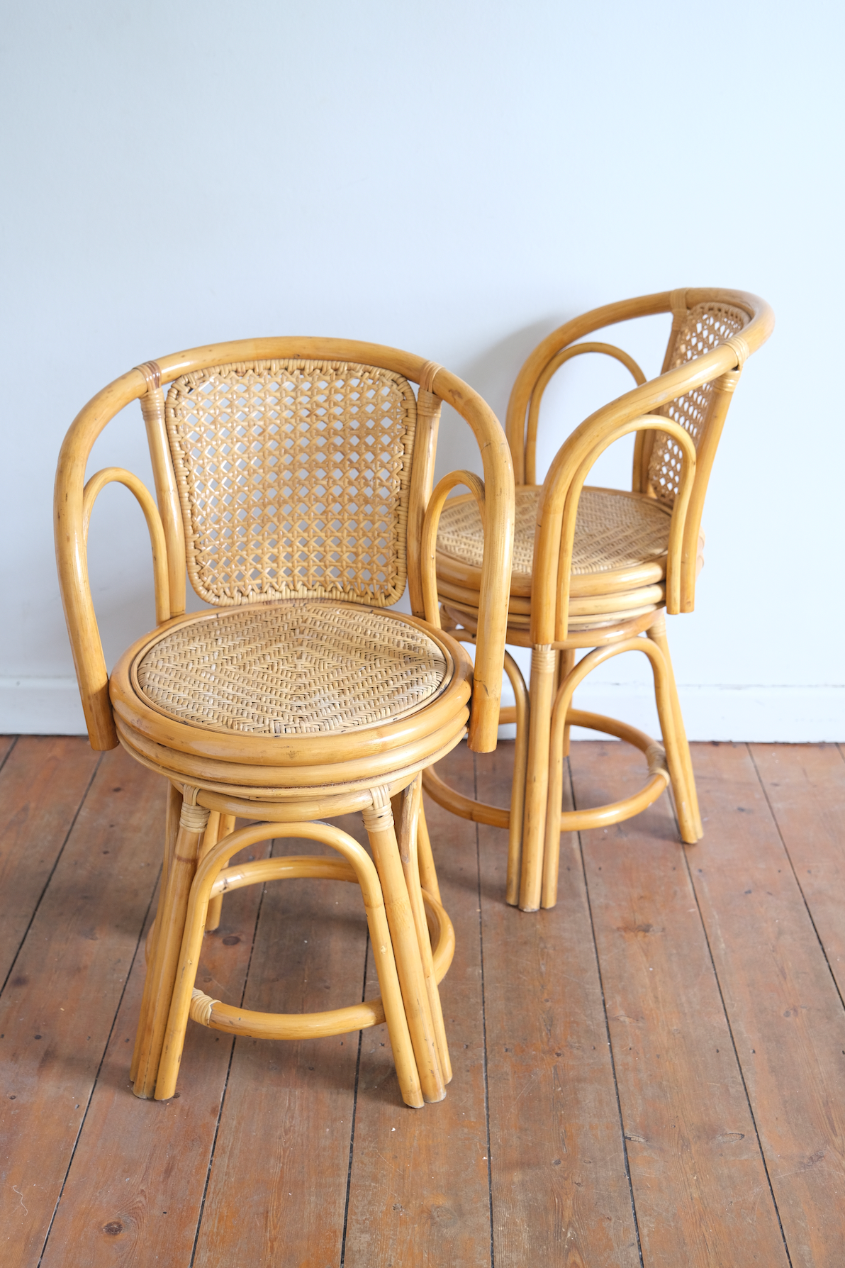 Pair of swivel cane chairs